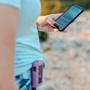 woman outside checking health stats on phone